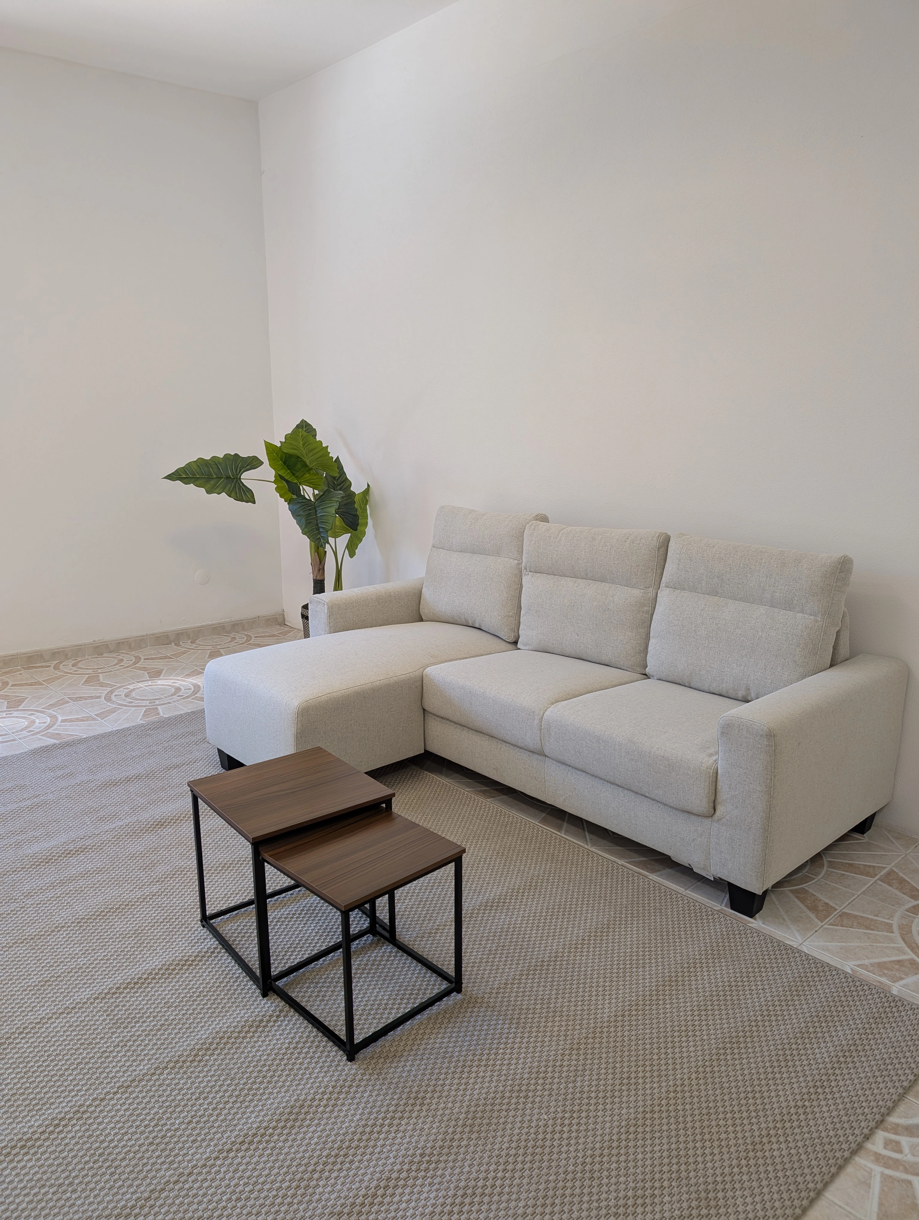 Sofa area with a small table prepared for a relaxed reception.